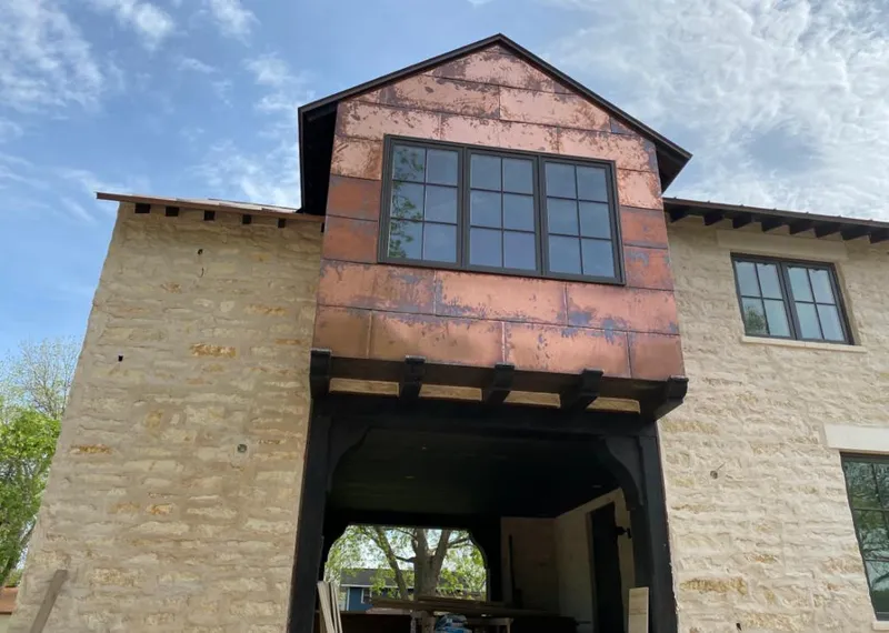 Copper metal panel facade on a stone building for Roof Repair in Cooper City