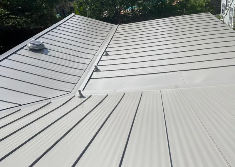 Solar attic fan installed on a metal roof for Roof Ventilation in Cooper City